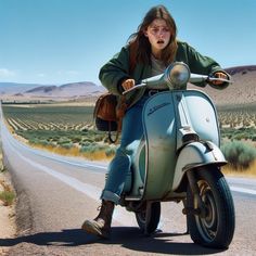 a woman riding on the back of a blue scooter down a desert road