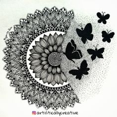 some butterflies are flying around a black and white flower with an intricate design on it