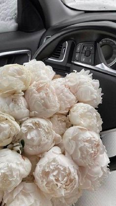 a bunch of white flowers sitting inside of a car