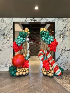 an entrance decorated with christmas decorations and balloons