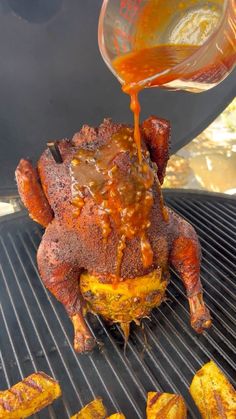 someone is pouring sauce on top of a roasting chicken