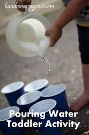 a toddler pouring water into buckets with the words pouring water toddler activity