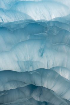 an airplane flying over the top of a glacier