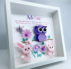 an owl and two rabbits in a shadow box with the words adelinne on it