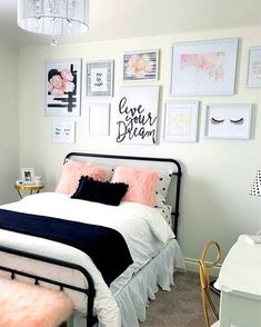 a white and black bedroom with pictures on the wall