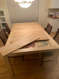 a wooden table and chairs in a room