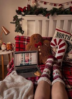 a person laying in bed with their feet on the laptop