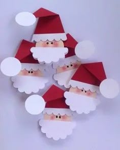 paper santas with red and white hats on them