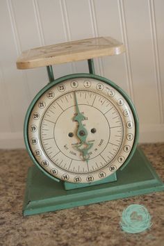 an old green scale sitting on top of a counter