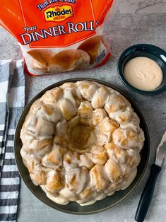 a bundt cake sitting on top of a plate next to a container of cream cheese