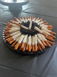 there is a cake made out of sticks and marshmallows on the plate