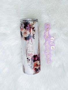 the tumbler is decorated with flowers and sparkles