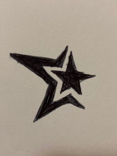 a drawing of a black star on white paper