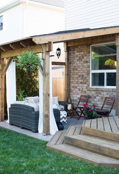 an outdoor living area with wooden decking and patio furniture