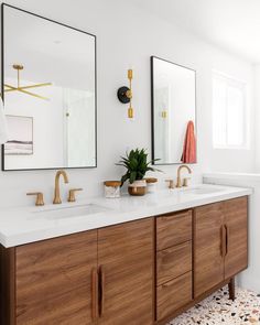 a bathroom with two sinks and mirrors on the wall next to a bath room sink