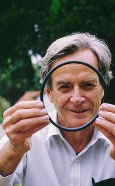 a man looking through a magnifying glass with a quote from richard ferryman