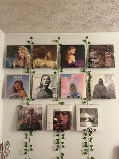 there are many pictures hanging on the wall with ivy growing up to it's sides