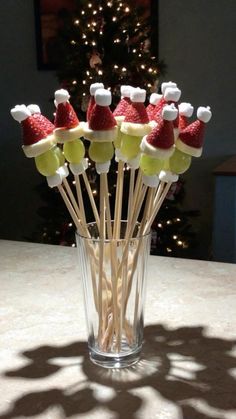 a glass filled with marshmallows and santa hats