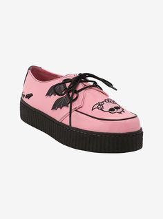 a pink shoe with black laces and skulls on it