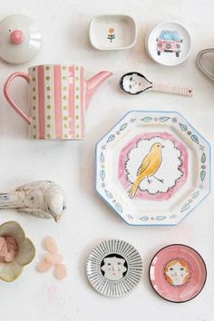 plates, cups and spoons are laid out on the table to be used as decorations