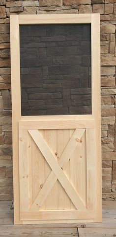 a wooden frame with a chalkboard attached to the side and an open barn door