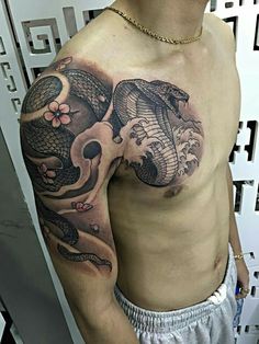 a man with a dragon and snake tattoo on his chest