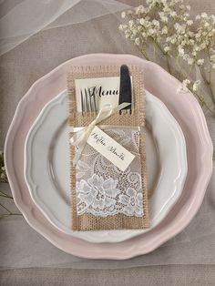 a table setting with place settings and napkins on it, along with some baby's breath flowers