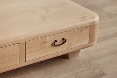 a wooden coffee table with two drawers on each side and an open drawer at the top