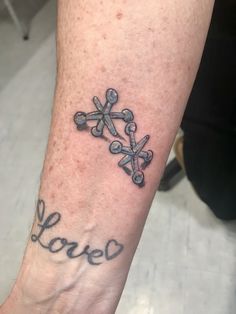 a person with a tattoo on their foot that reads love and has an arrow in the middle