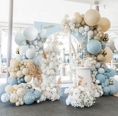 an arch made out of balloons and flowers