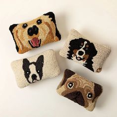 four decorative pillows with dogs on them