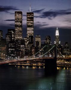 the city skyline is lit up at night