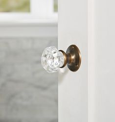 an open door with a glass knob on it