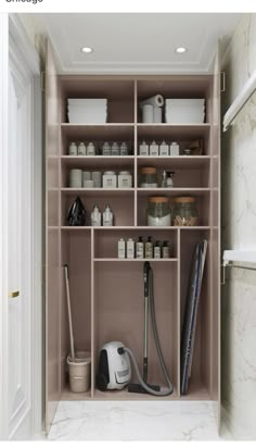 an open shelf with various items in it and a vacuum on the floor next to it