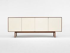 the sideboard is white and has four doors on one side, two drawers on the other