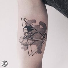 a person with a tattoo on their arm is holding onto a piece of artwork that looks like a triangle