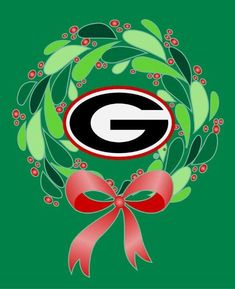 the green bay packers christmas wreath with a red bow on it's front and side