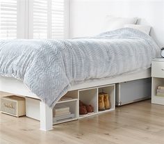 a white bed sitting on top of a wooden floor