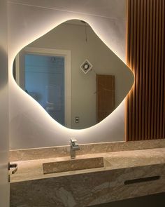 a bathroom with a large mirror on the wall above it and a sink below it