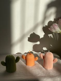 three small cactus candles sitting on top of a table