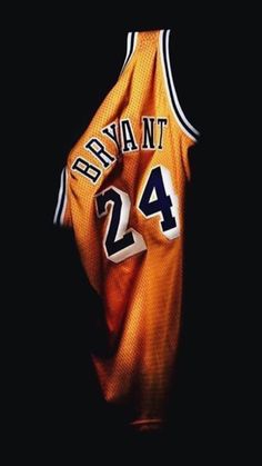 a basketball jersey with the number 24 on it is hanging in front of a black background