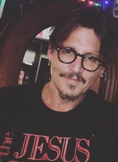 a man with glasses and a mustache wearing a t - shirt that says the jesus