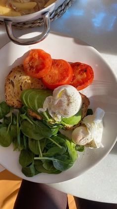 a white plate topped with bread and veggies