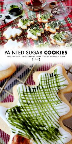 some cookies that are on a table with green and white icing in the shape of a christmas tree