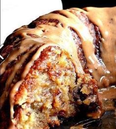 a bundt cake covered in icing and drizzled with caramel