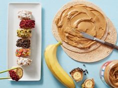 an assortment of desserts with peanut butter and bananas on a blue surface next to each other