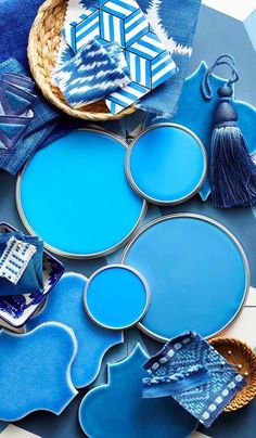 some blue plates are sitting on a table with other items in the shape of snowflakes