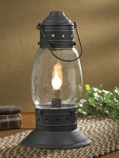 a glass lantern sitting on top of a table