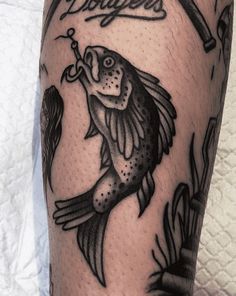 a man's leg with a fish tattoo on it and the words fishing written in cursive font