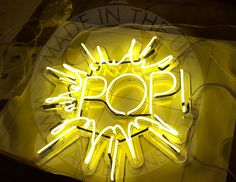 a neon sign with the word pop on it